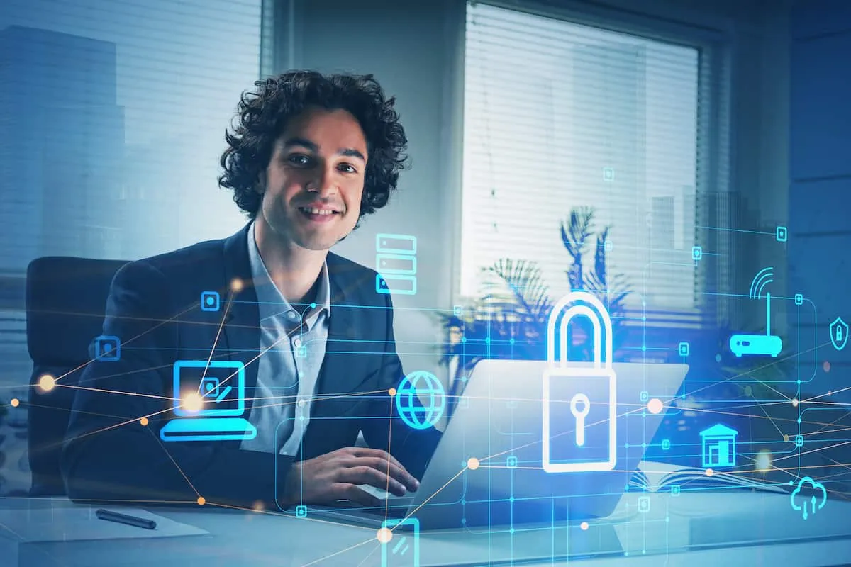 A man at a laptop with padlock and network icons drawn over the desk