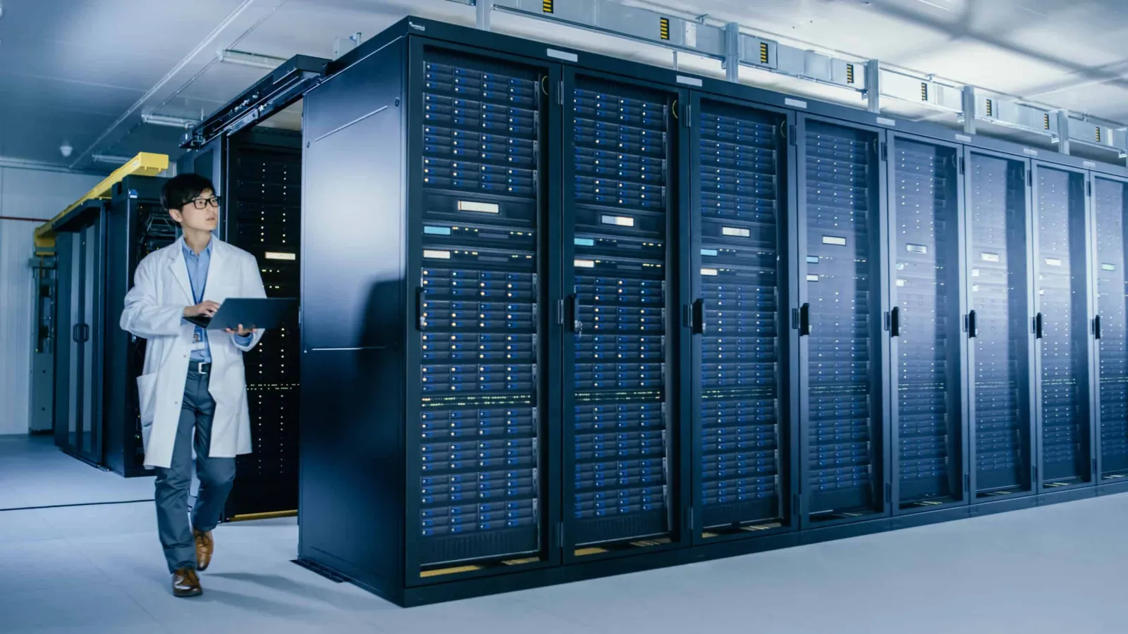 Rows of server cabinets in a data center aisle